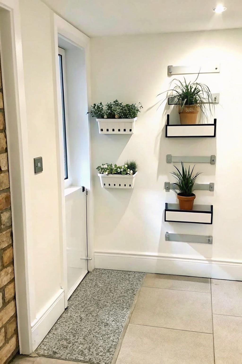 White interior hallway with narrow wall shelves holding potted plants above a tiled floor next to an open door.