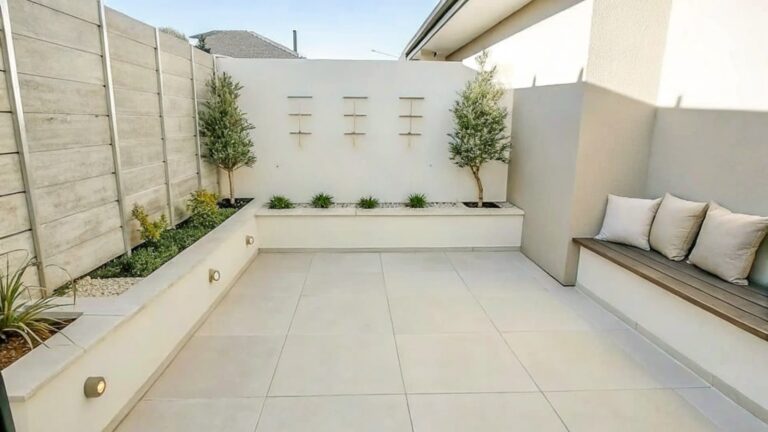 Modern courtyard with stone pavers, vertical plant ladder, wooden bench, and potted tree