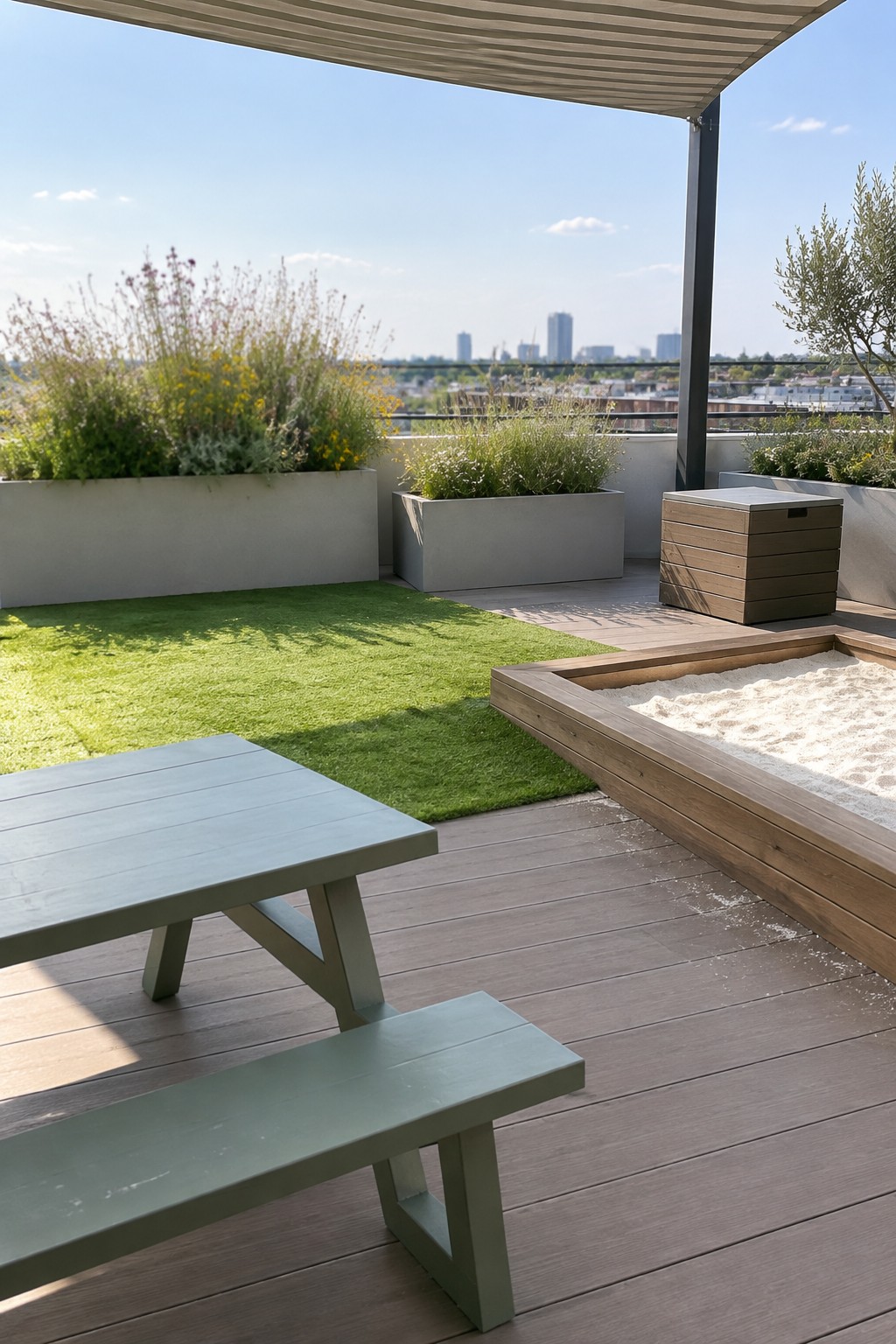 Rooftop deck with green picnic table, wooden sandbox, planters, and city skyline view.