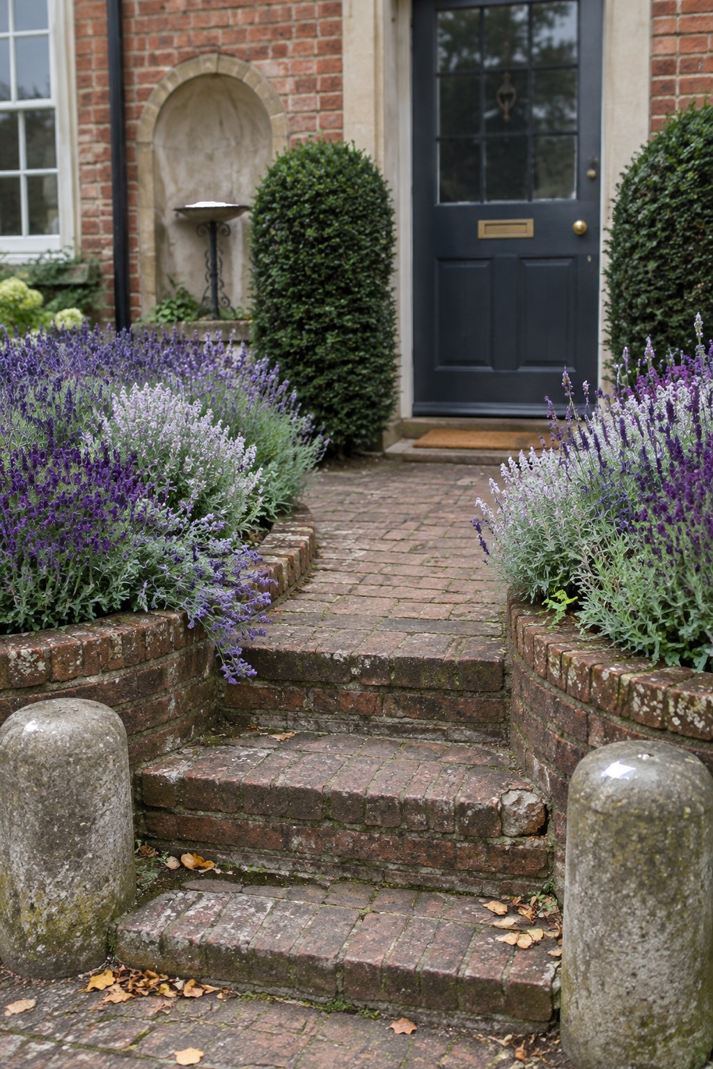 Brick steps lead through lavender beds to a dark front door.